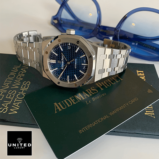 Audemars Piguet Royal Oak Blue Dial Inspired side view next to warranty card