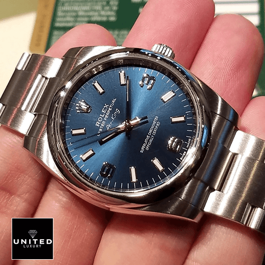 Rolex Air King 114200 Blue Dial Inspired on the hand and next to warranty card