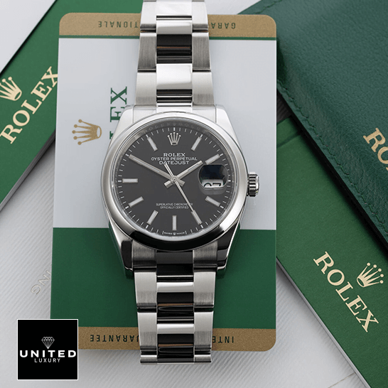 Rolex Datejust 115200 Black Dial Inspired next to warranty card