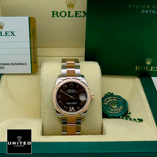 Rolex Datejust178341 Chocolate Roman Inspired warranty card in the box next to it