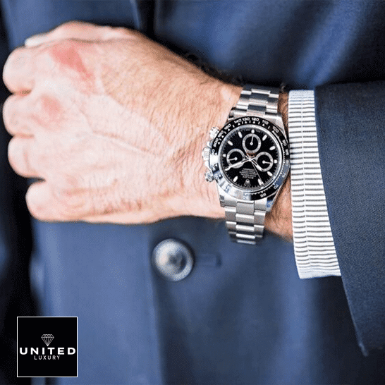 the man in the suit has a Rolex Daytona 116500ln-0002 Inspired